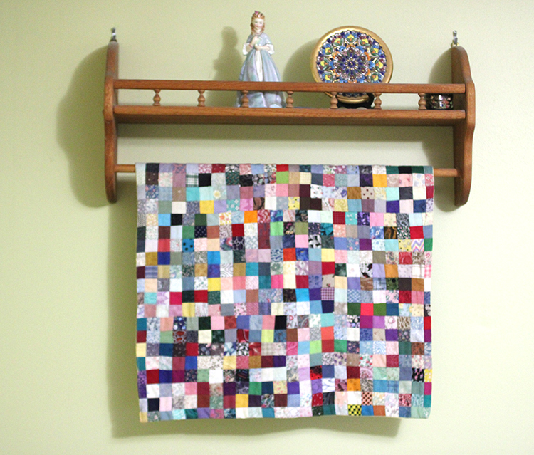 wall quilt on a quilt rack