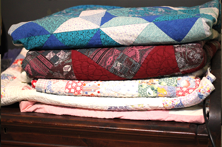 folded quilts in a stack