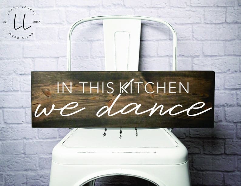 In this kitchen we dance wood sign