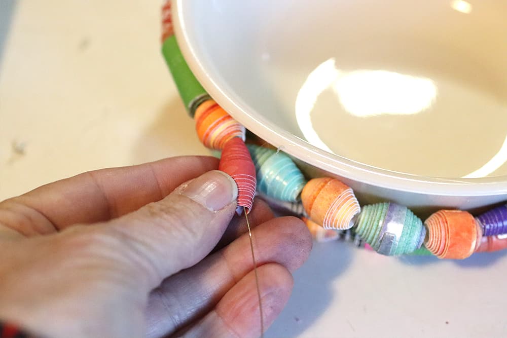 Continue gluing wried beads around the bowl.