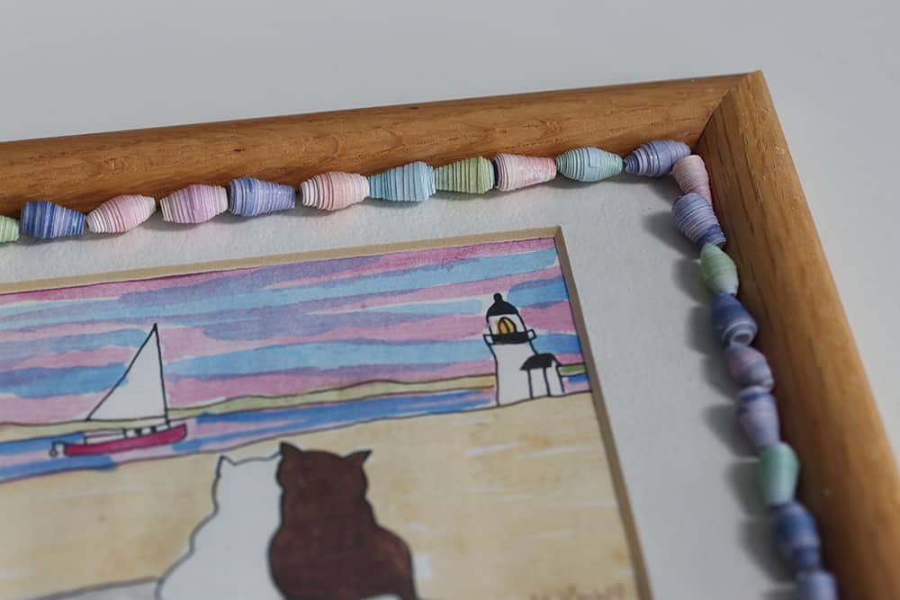 What to make with paper beads- Glue paper beads to a picture frame or the glass to customize the frame 