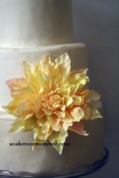 Crepe paper flower displayed on a cake