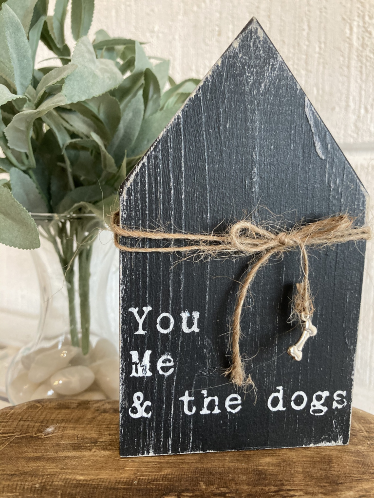 wooden sign that says "you me and the dogs"
