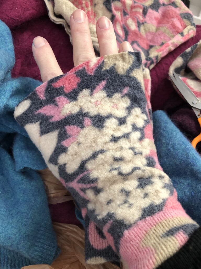 cut off the sweater sleeve slightly above the knuckles