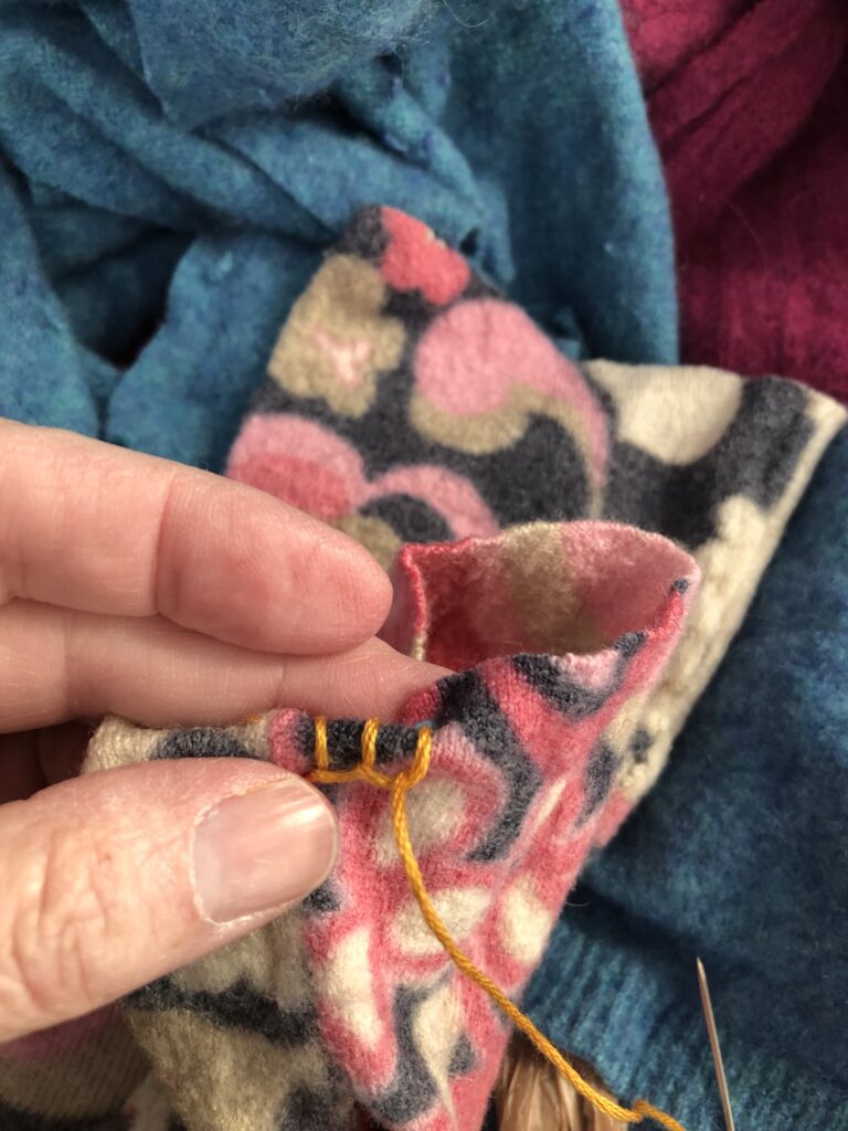 sew the hem with a blanket stitch