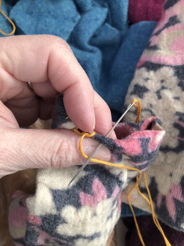 Sew the hem with a blanket stitch