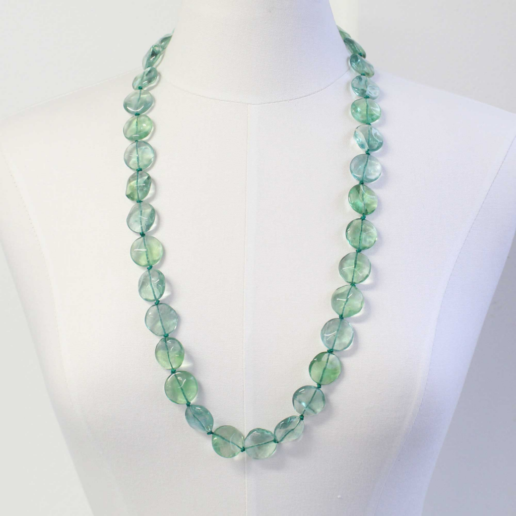 long green fluorite necklace on a mannequin