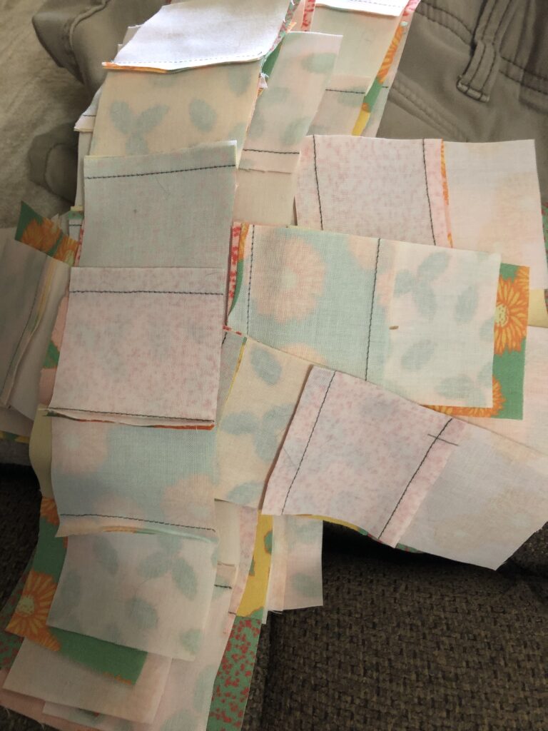 Small squares sewn together in strips