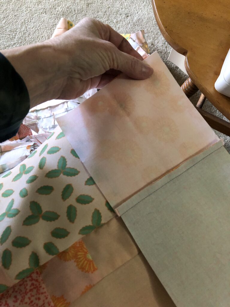 Matching the inner border to the main quilt top before sewing it on