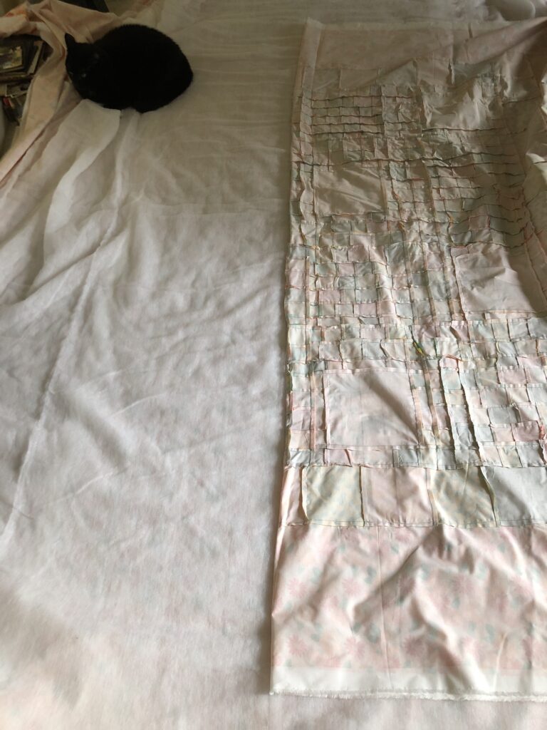 Putting the quilt top on the batting, starting in the center
