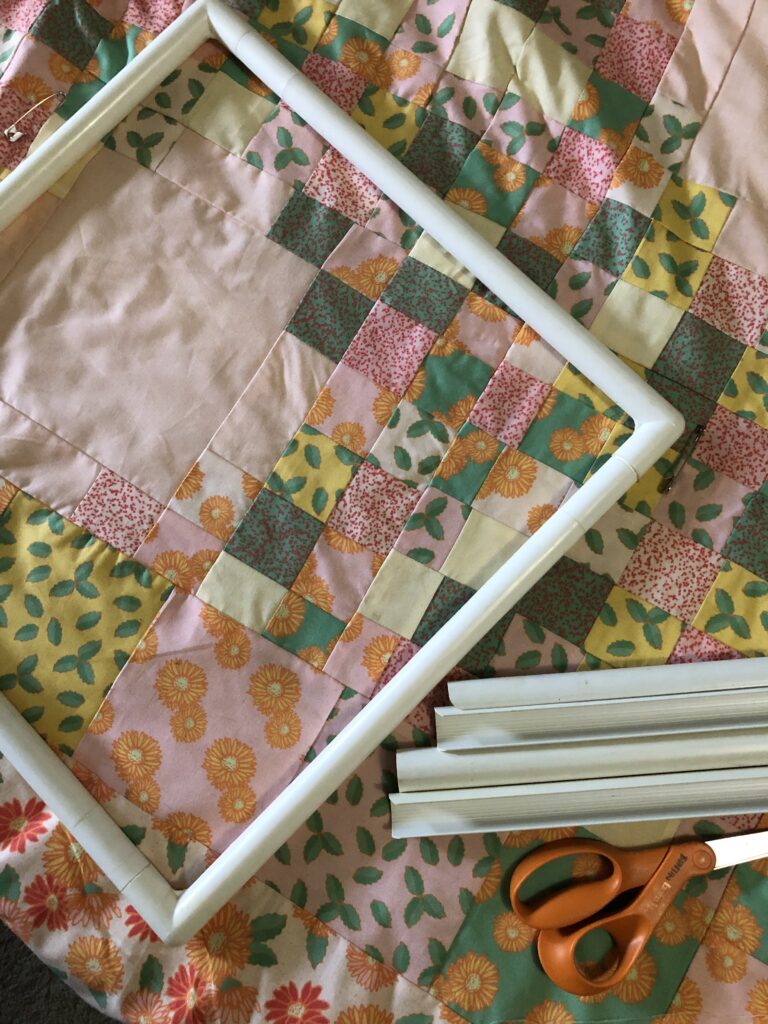 Quilt and the quilting frame ready to put onto the quilt