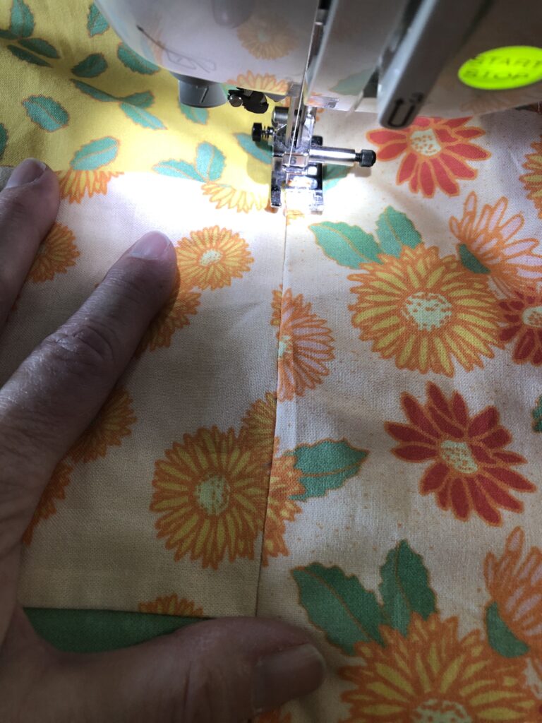 Stitch in the ditch on the seams of the quilt