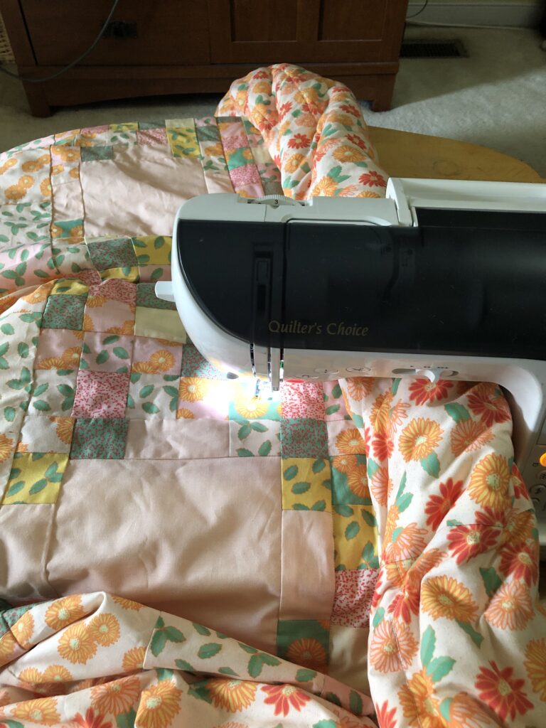 quilt rolled in the throat of the sewing machine