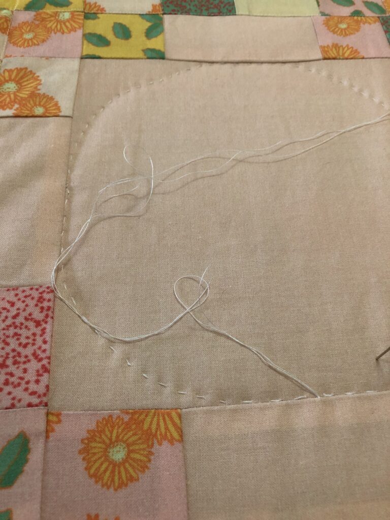 hand-stitched design on a quilt top