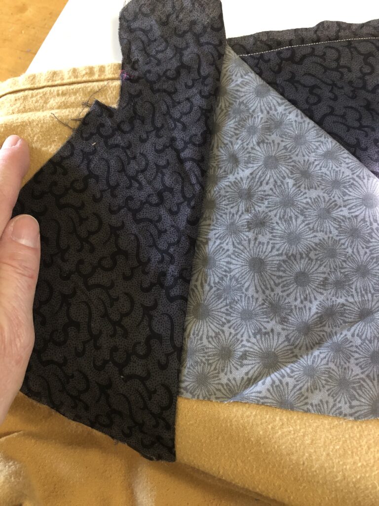 turn the piece of fabric over to show the right side of the pattern