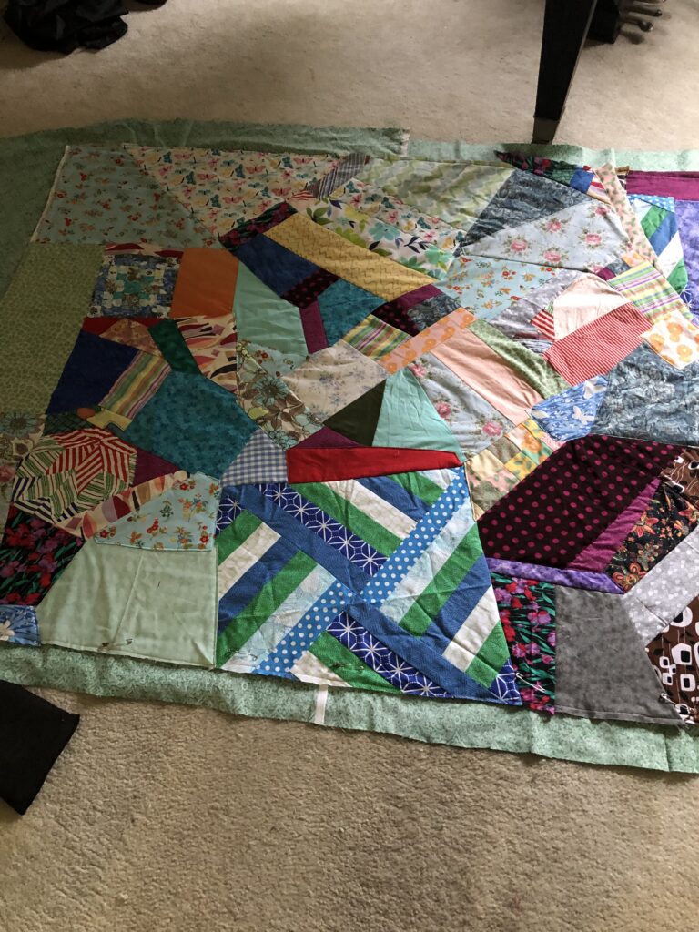 the quilt with the binding edge showing before it's been turned over on the edge