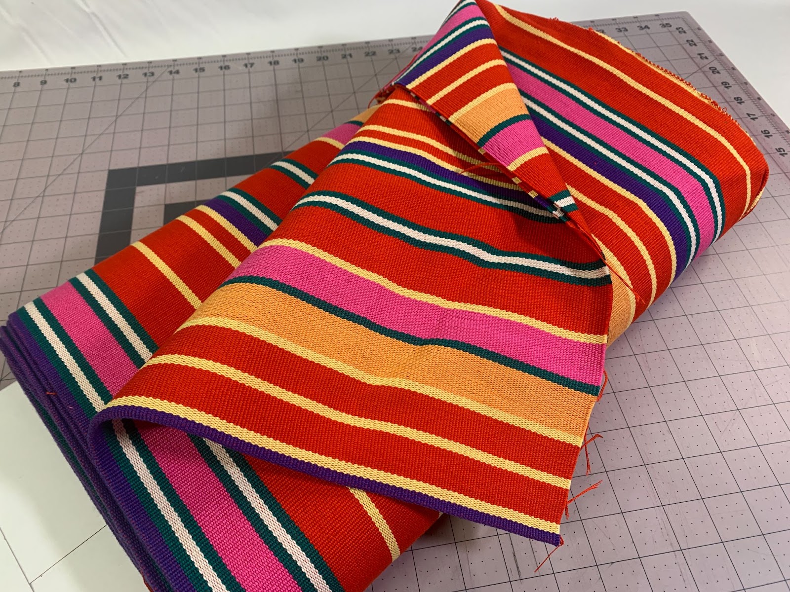 striped fabric on a cutting mat