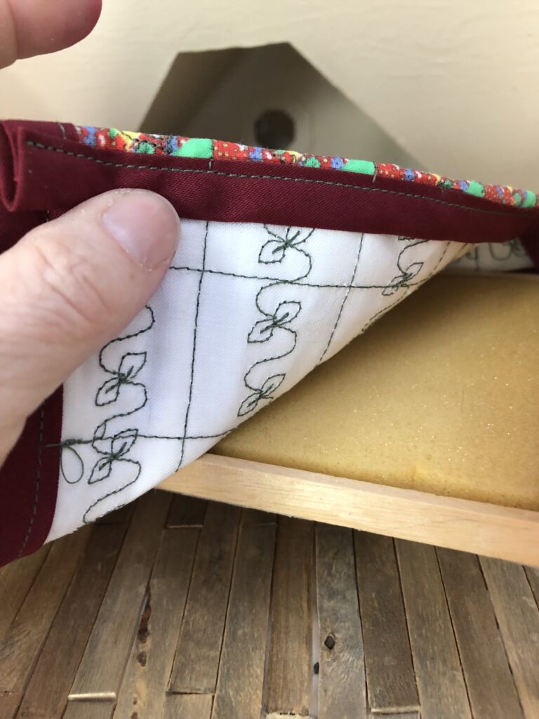 decorative stitching on a dollhouse quilt