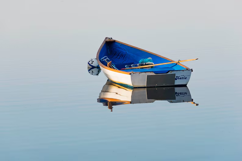 fine art photo of a boat floating on the water