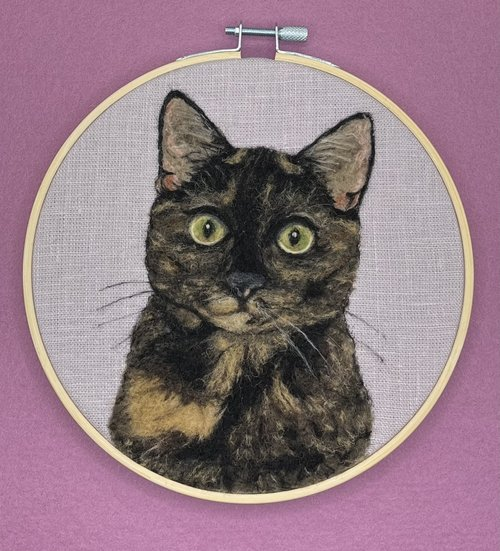 portrait of a cat in an embroidery hoop