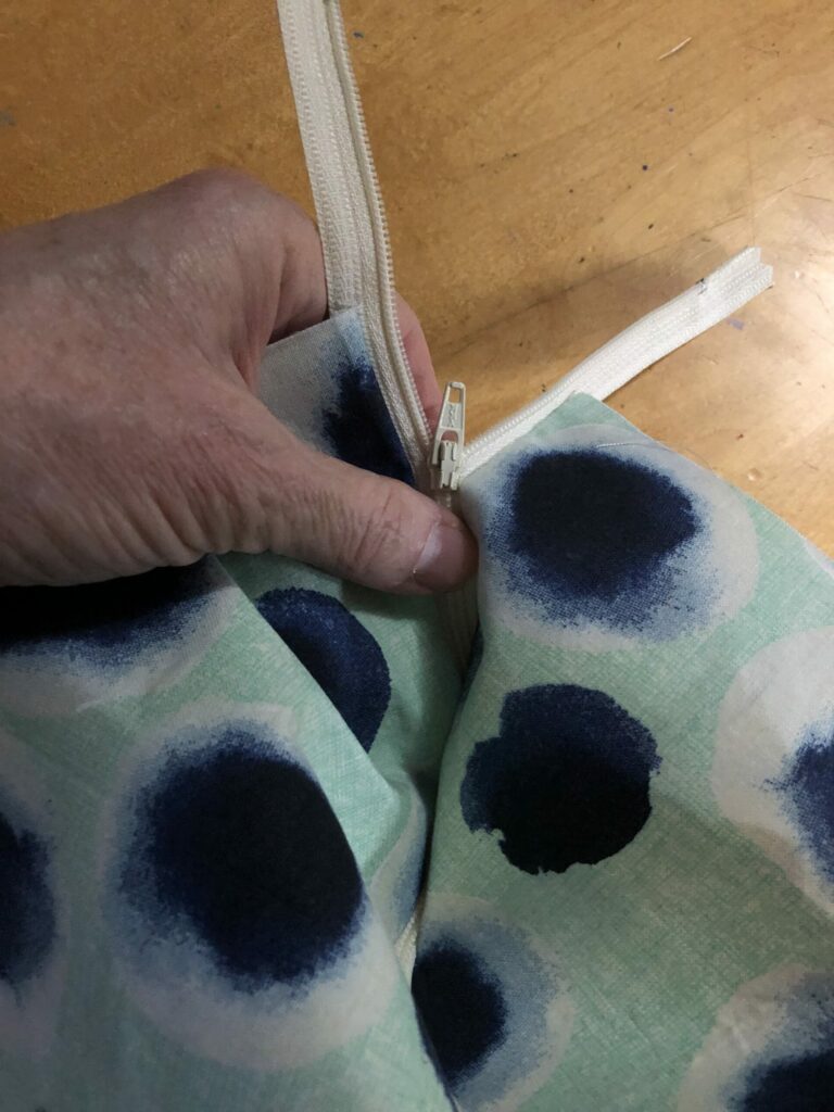The zipper attached to the main fabric pieces