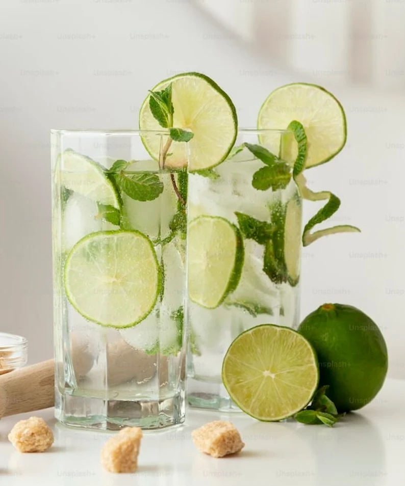 glasses with mojitos and limes